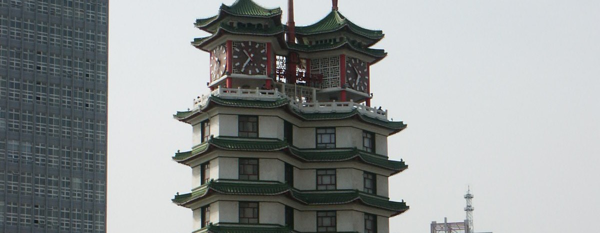 The twin pagoda towers of Erqi Memorial Tower over the city square