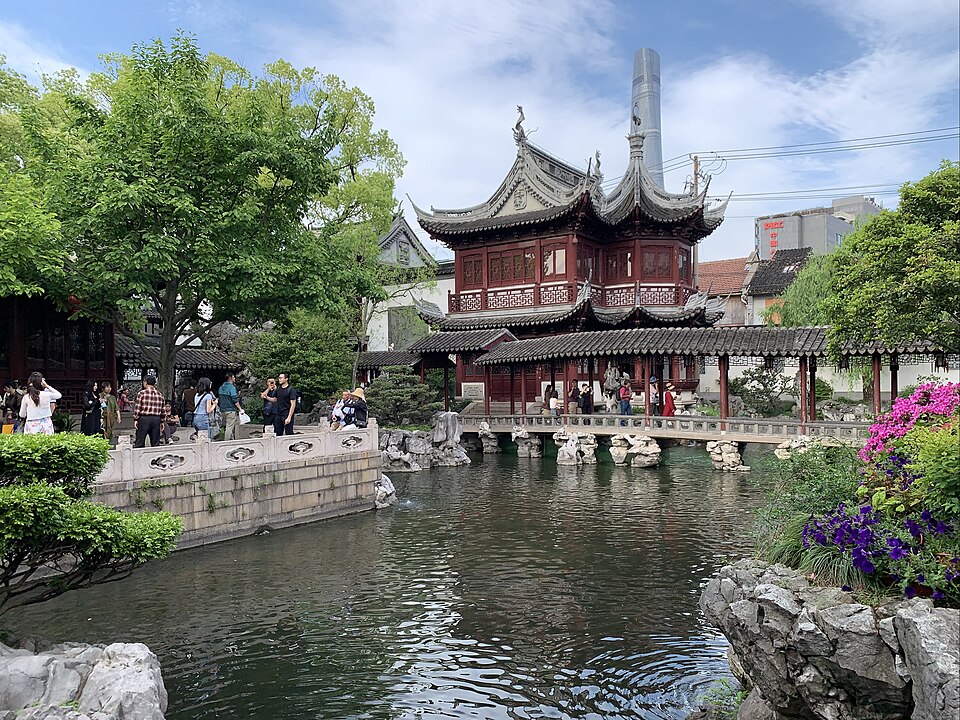 A classical Chinese garden pavilion mirrored in still water at Yu Garden, Shanghai